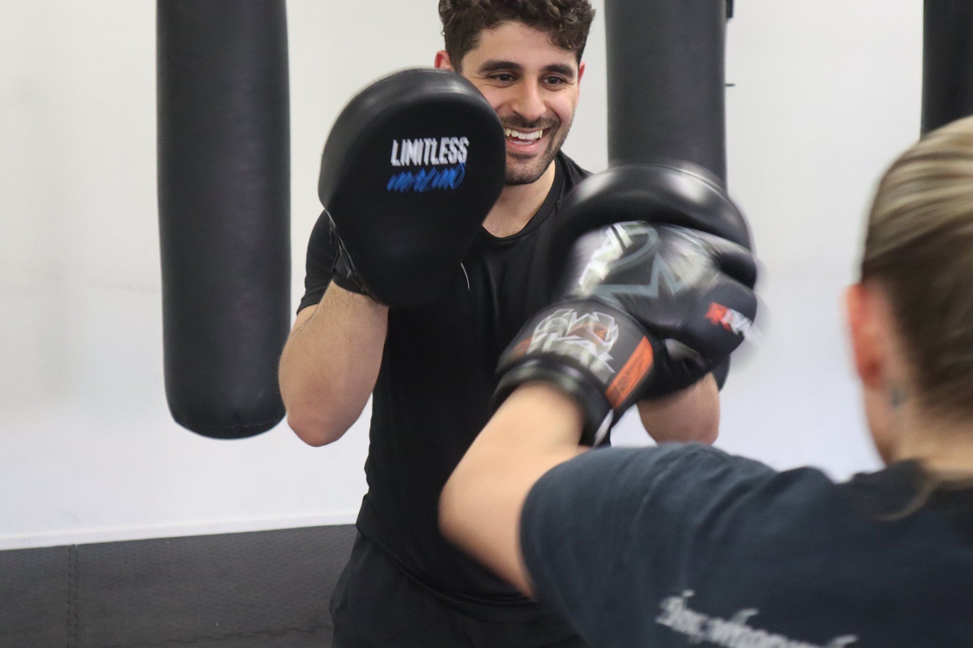 Member hitting pads at Limitless Boxning