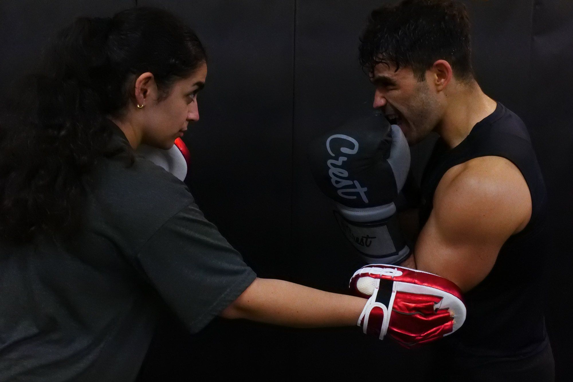 Beginner practising punches on pads